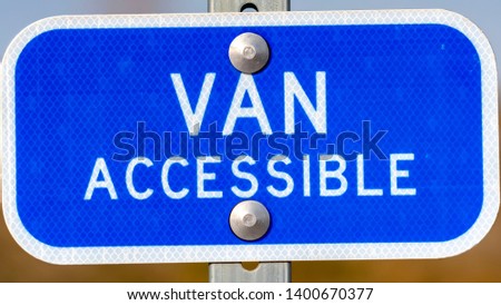 Clear Panorama Blue sign with a Van Accessible text on a parking area for handicapped people