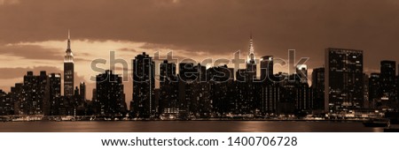 Midtown Manhattan skyline at dusk panorama over East River in BW