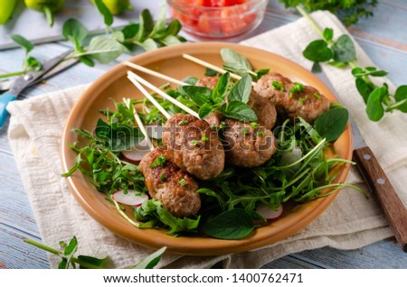 Hot and spicy delicious meat, grilled with fresh garlic and herbs, fresh salad