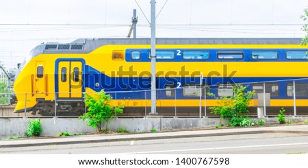 Dutch train with a road in the foreground