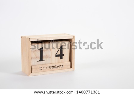Wooden calendar December 14 on a white background close up