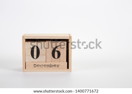 Wooden calendar December 06 on a white background close up