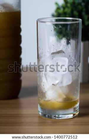 filling an empty ice cold glass with sugar cane