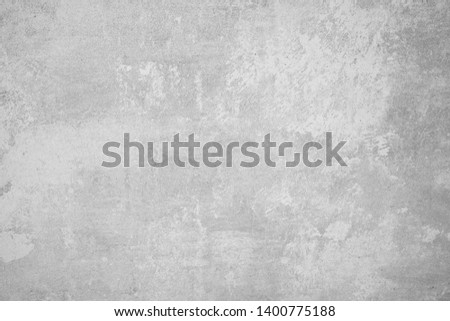 Wall fragment with scratches and cracks. Black and white textured weathered gray color handmade surface for background.