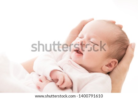 Newborn Baby Sleep on Mother Hands, New Born Girl Smiling and Sleeping, Happy Two Weeks Old Child on White Royalty-Free Stock Photo #1400791610