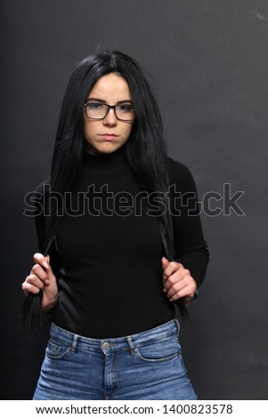 Beautiful girl with black hair posing in studio