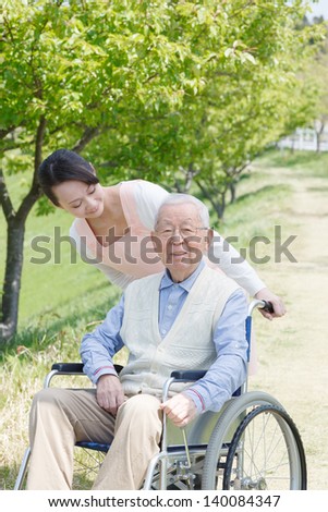 Japanese caregivers and senior smile in the field