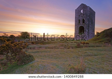 Cornwall's industrial heritage, the rugged beauty of Bodmin Moor with a stunning pink sunrise over the ruins of the Engine House of the Wheal Jenkin mine at Minions, Cornwall, England, UK