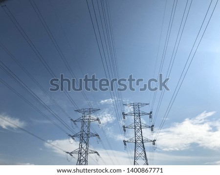 High voltage poles with blue sky background