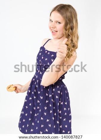 Smiling teenage girl holding a delicious cake