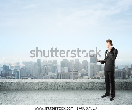 man standing on roof and talking on phone