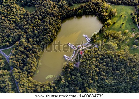 Some boats and sailboats at marina - drone view from above at a lake in Poland, Mazury