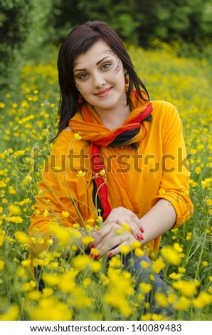 Portrait of beautiful girl in flowers with picture on face