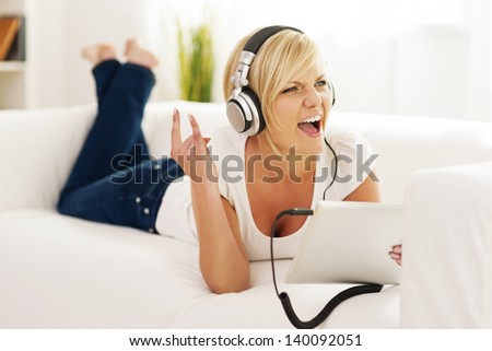 Woman listen to rock music at home  