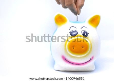Piggy bank and hand with coin. on background White with copy space. Money saving concept
