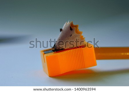 A simple pencil in a sharpener with shavings