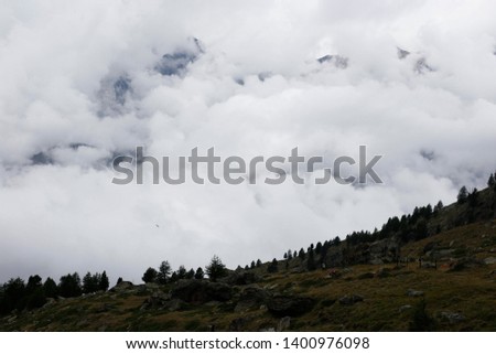 Alpine scene with clouds among the mountains.