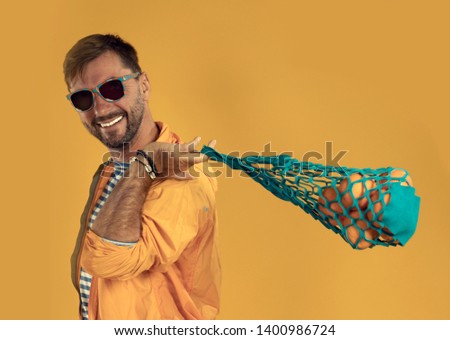 Man with oranges in a shopping bag