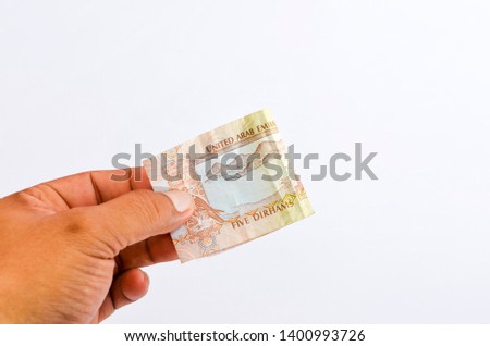 5 United Arabian Emirates dirham banknote on white background. Dirham is the national currency of the United Arabian Emirates. Selective focus.