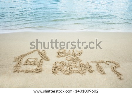 Buy Or Rent Text With Drawn House On Sand Near The Sea At Beach