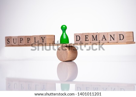 Words Demand And Supply Wooden Block Balancing On Seesaw Royalty-Free Stock Photo #1401011201