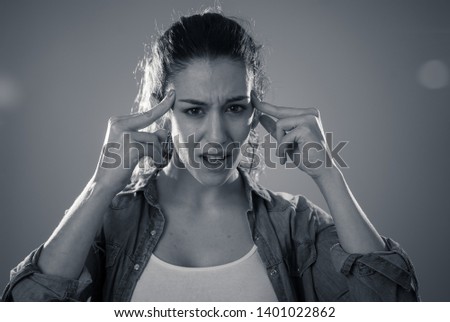 Close up portrait of a young woman looking worried and thoughtful suffering from migraines in great pain. Isolated on neutral background. In facial expressions and emotions and health care concept.