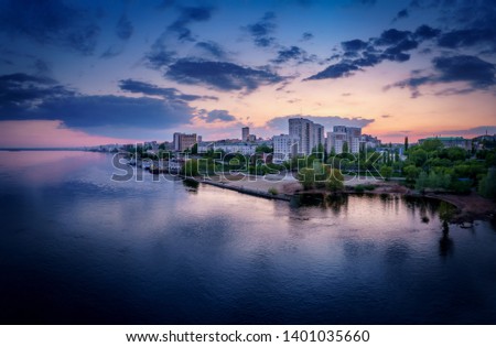 Saratov city skyline at sunset, panoramic view to quay from the bridge on Volga river. Russia