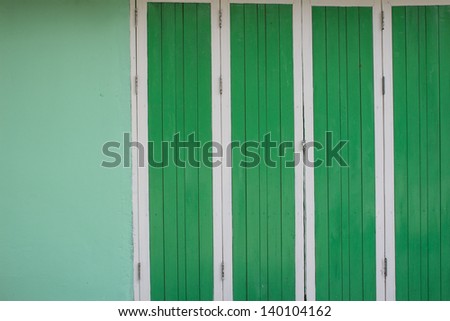 Green wood door and cement wall