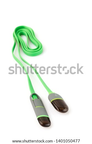 Green plastic cable USB-Lightning on white background. Close-up