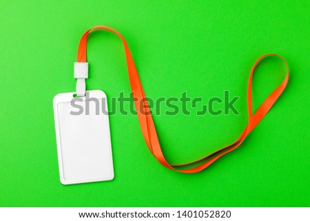 Blank security tag with a red stripe neck on a green background. Place for text, layout.