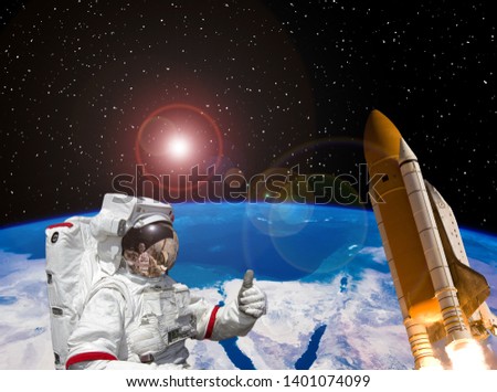 Astronaut and rocket above the earth. Space concept. The elements of this image furnished by NASA.
