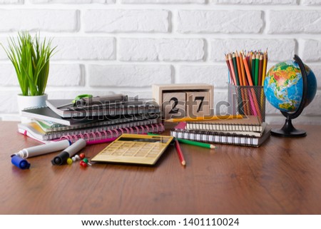 School supplies in classroom on table
