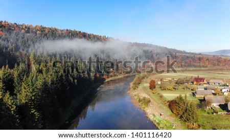 Over the mountain river Stryi. Beautiful autumn nature in Carpathians, Ukraine