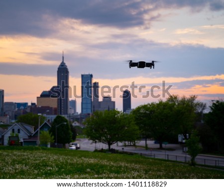 Flying drone with Indianapolis city skyline in the background