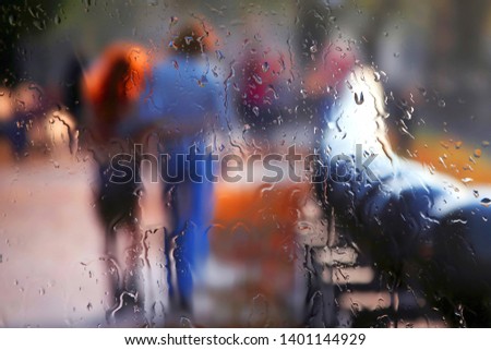 vague silhouette of two people through rainy glass. romance and family relationships in urban life
