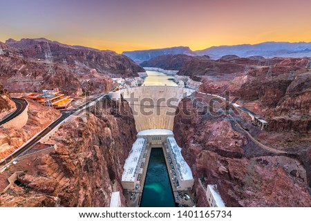 Hoover Dam on the Colorado River straddling Nevada and Arizona at dawn from above. Royalty-Free Stock Photo #1401165734