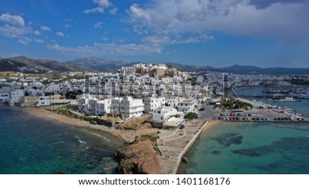 Aerial drone photo of iconic chora, main town of Naxos island with beautiful uphill castle with views to the Aegean deep blue sea, Cyclades, Greece