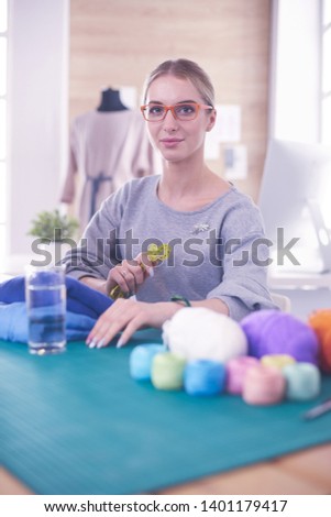 Fashion designers working in studio sitting on the desk
