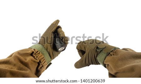 Isolated photo of a first person view arms in tactical jacket and gloves holding portable military flashlight on white background.