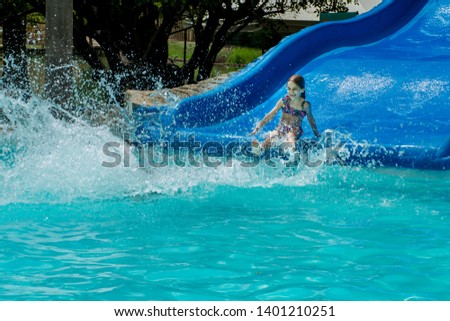 Little girl on water slide in the water park