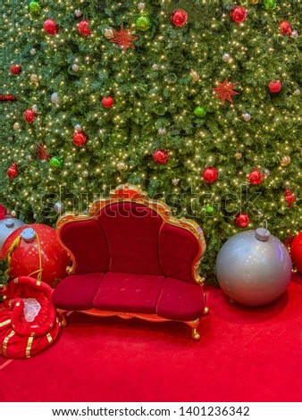 Santa's chair in front of Christmas tree.