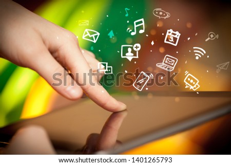 Hand holding tablet with drawn multimedia and application icons