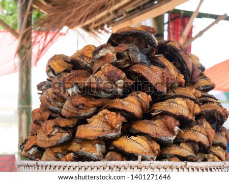 Grilled striped snakehead fish or Channa striata for sale in the market. Heap of grilled striped snakehead fish.