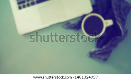 Blurred background coffee cup and laptop with English language keyboard flat lay on vintage green painted wooden background. Top view with space for text e.g. inspirational and motivational quotes.