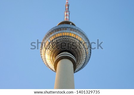 The TV Tower on the Alexanderplatz in Berlin, Germany, alluminated with sunshine and with blue sky on the background.