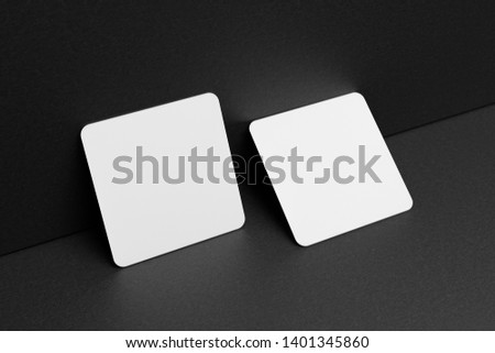 3D render Mock-up of the two square business cards are on a black paper