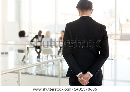 Nervous businessman waiting to enter at business meeting rear view, male employee, presenter, speaker worried about presentation for colleagues in boardroom, applicant waiting interview in hallway Royalty-Free Stock Photo #1401378686