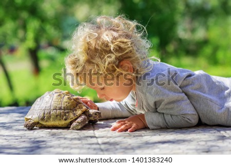 lovely boy with turtle outdoor