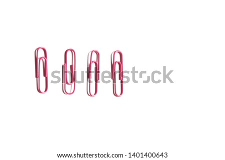 A row of pink paper clips on white isolated background 