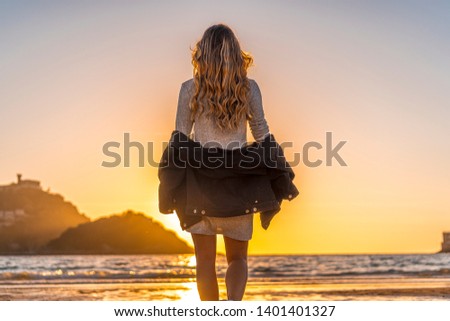 Girl on vacation at a sunset in San Sebastian